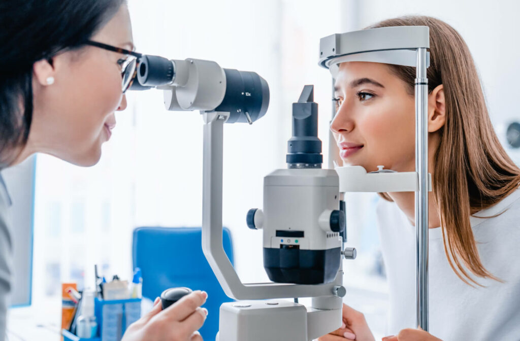 A female eye doctor examining the eye of a patient.