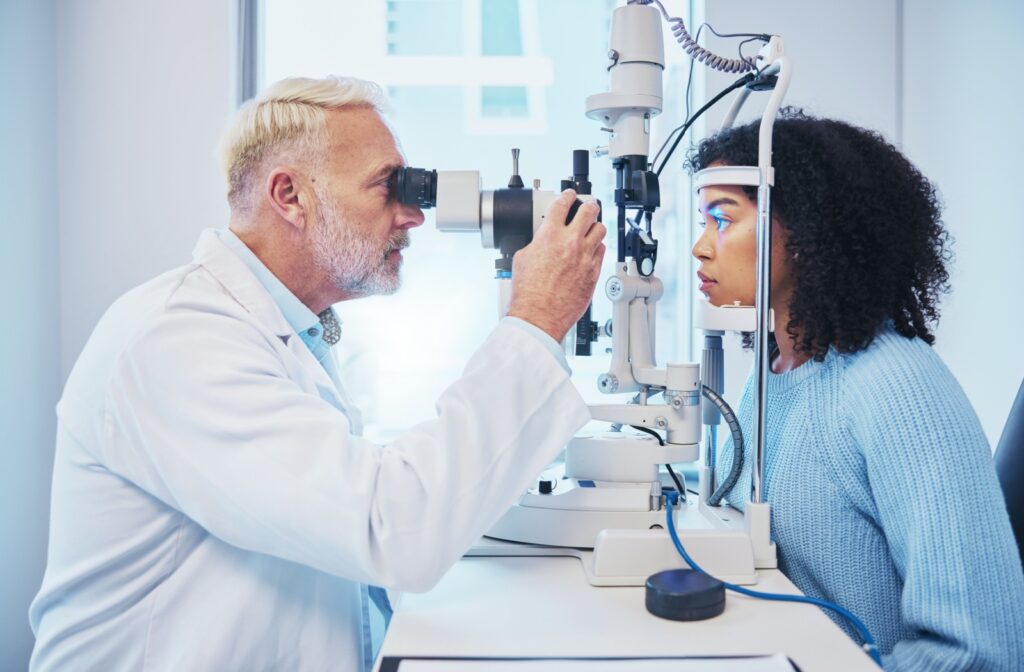 A patient examining his patient's eyes during a consultation to determine if she qualifies for LASIK.