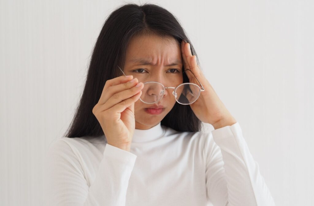 A person struggling with eye floaters, trying to figure out what is causing them.