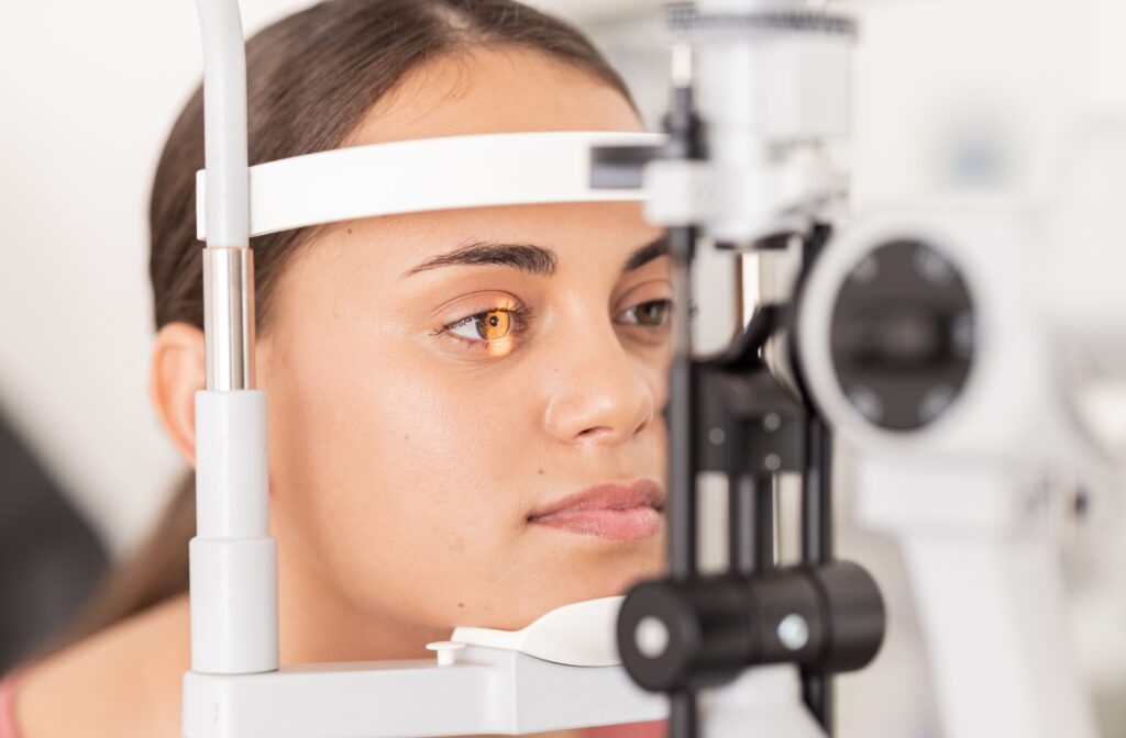 A patient having a slit lamp exam to check brown spots on their iris during their routine eye exam.