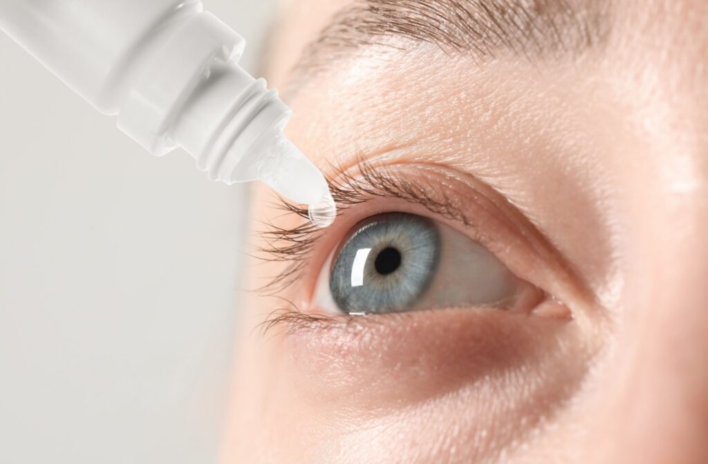 Close-up of a blue eye receiving prescription eye drops for dry eye treatment.