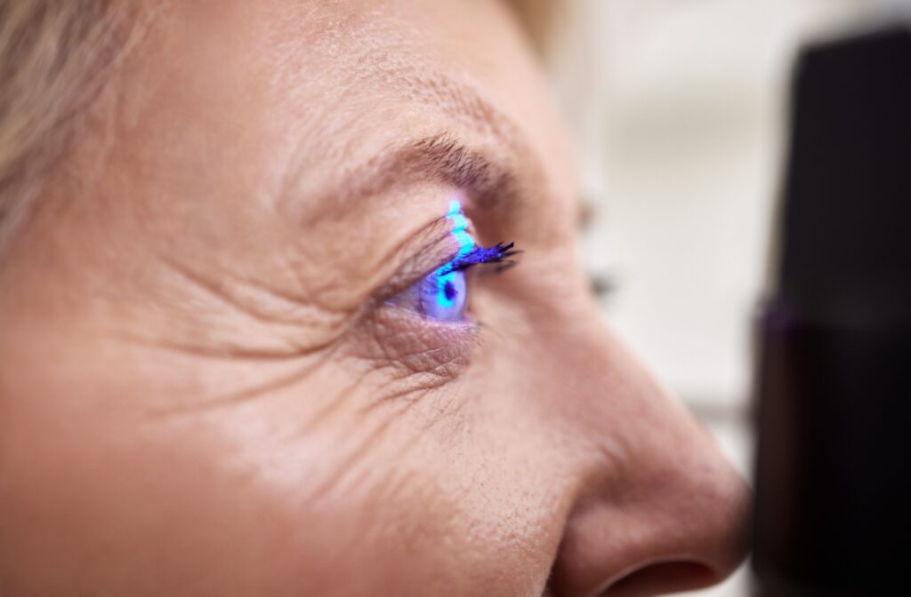 Close-up of an eye illuminated with blue light during a diagnostic eye exam at an optometry clinic.